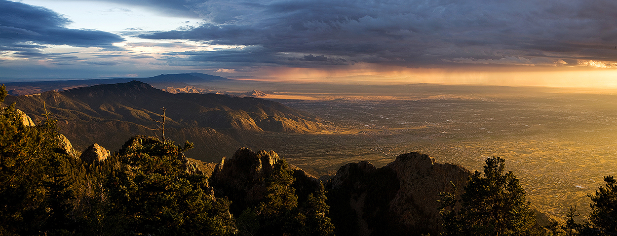 Fine art stock photograph from Albuquerque, New Mexico. A beautiful sunset clashes with a powerful monsoon storm over Albuquerque,, as seen from atop the Sandia Mountains.