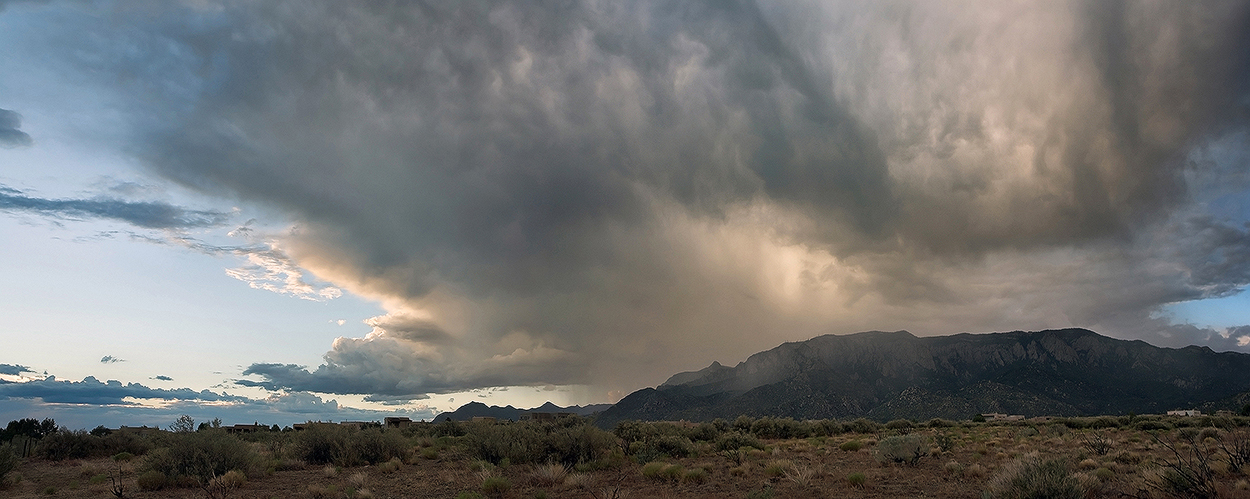 Supercell over Sandia Mountains Fine art stock photograph of a supercell towering high over the Sandia Mountains of New Mexico. Large storms such as this are common in New Mexico's monsoon season.