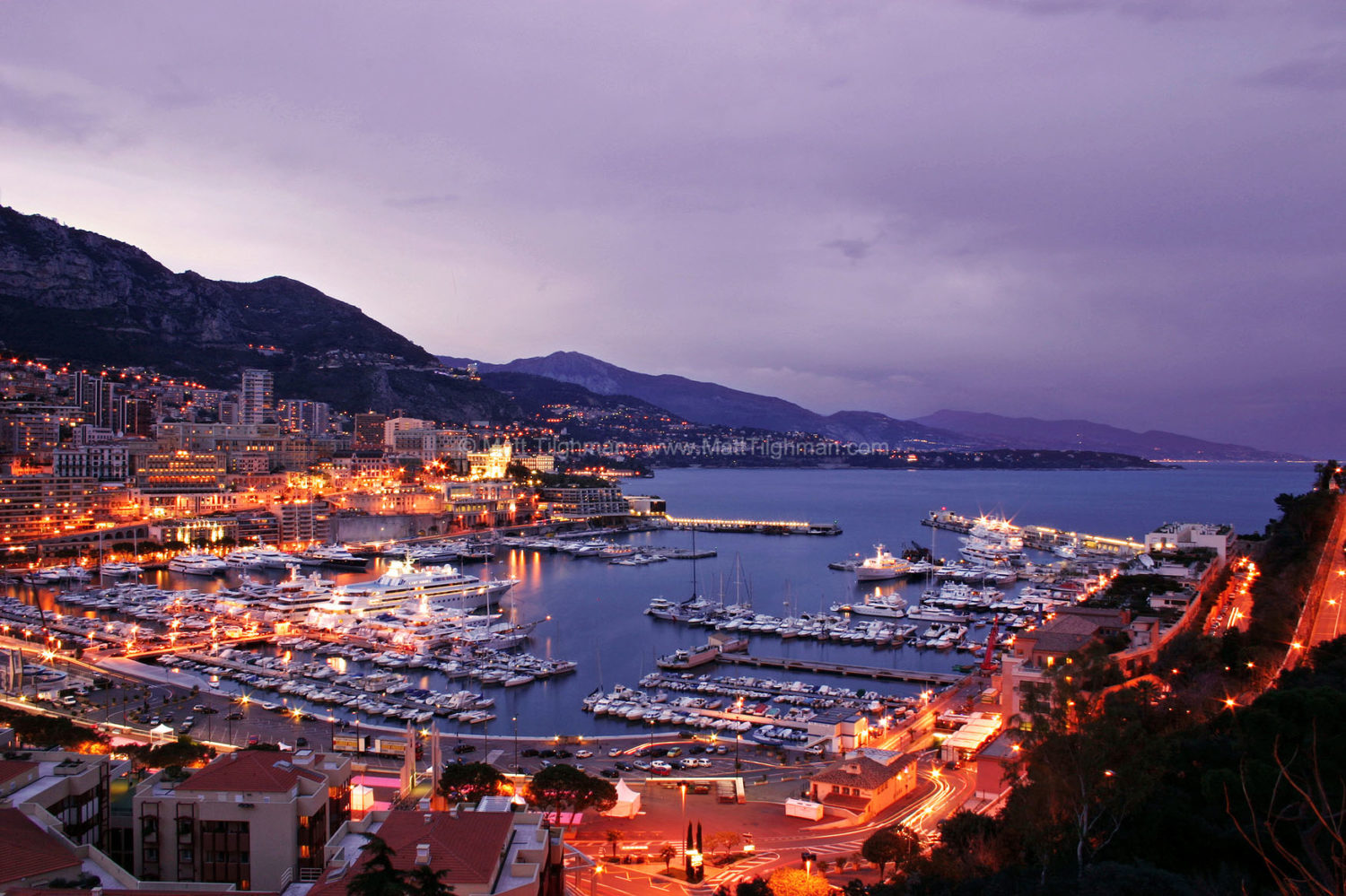 Fine art stock photo of Monte Carlo, Monaco, and the French Riviera. At twilight, the city begins to glimmer while the sea remains blue.