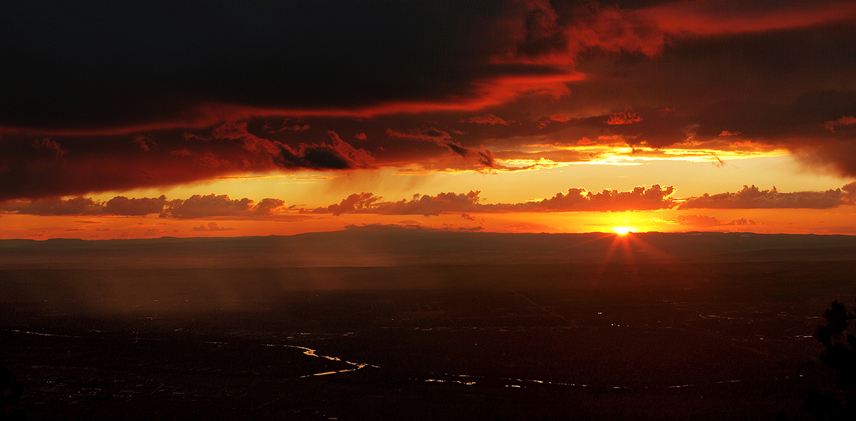 Fine art stock photograph of a summer monsoon outside Albuquerque, from atop the Sandia Peak at sunset.