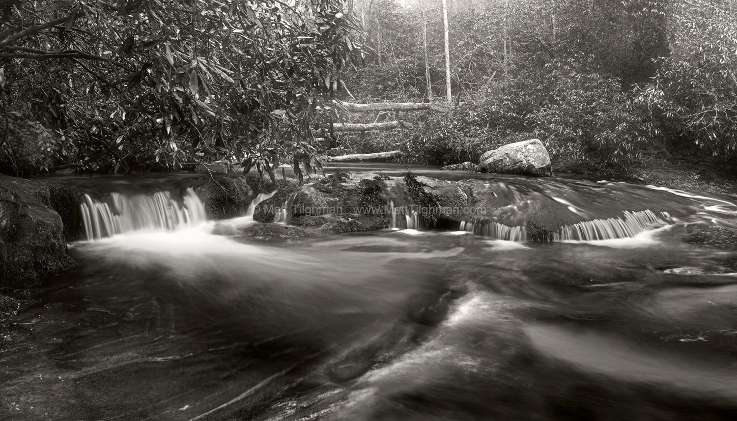 Fine art stock photograph of Chattooga River rapids in North Carolina. The frigid river mixes with Spring's warming air, shrouding the landscape in fog and mist.
