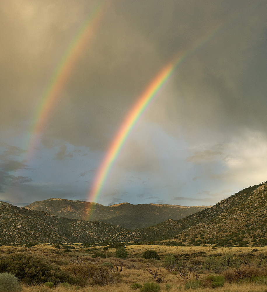Desert Double Rainbow - Chihuahuan Desert, New Mexico Fine art stock landscape photograph from outside Albuquerque, New Mexico. A desert double rainbow is the result of a summer monsoon over the Sandia Mountains.