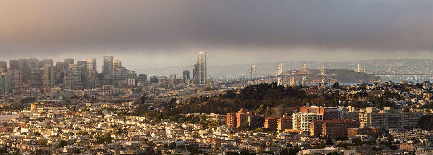 Fine art stock photograph from San Francisco. From Bernal Heights Park, you can watch the fog descend through the downtown skyline and out over the bay.