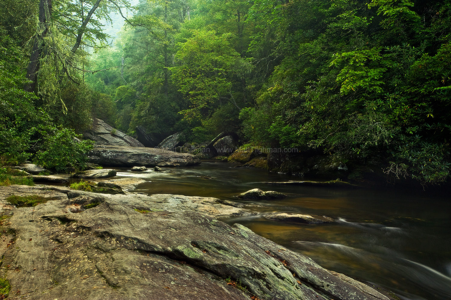 Fine art stock photograph of North Carolina's Blue Ridge Mountains at dawn. The Chattooga River cuts through ancient granite boulders in lush green forest.