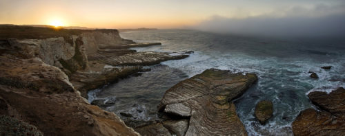 Fine art stock photograph from Panther Beach, near Santa Cruz California. The beautiful cliffs are greeted by Pacific Ocean fog, and a beautiful sunrise.