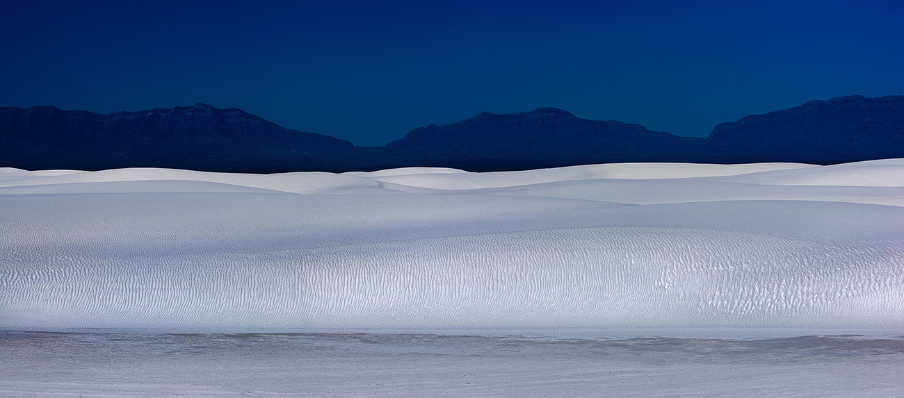 White Sand Dunes New Mexico Fine art stock photograph of White Sands National Monument, in New Mexico. The wave-like white gypsum dunes are among the most beautiful landscapes on earth.
