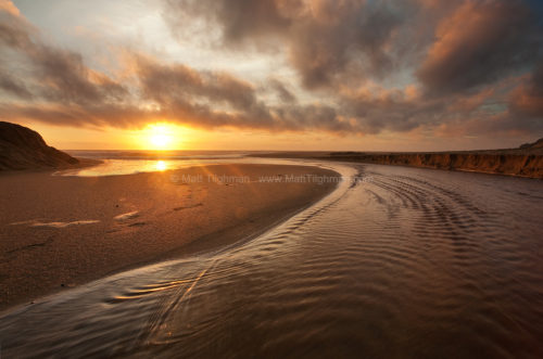 Fine art stock photograph from Montara Beach, near Pacifica, California. The dense fog broke up just before sunset, and lit up as the sun neared the horizon.