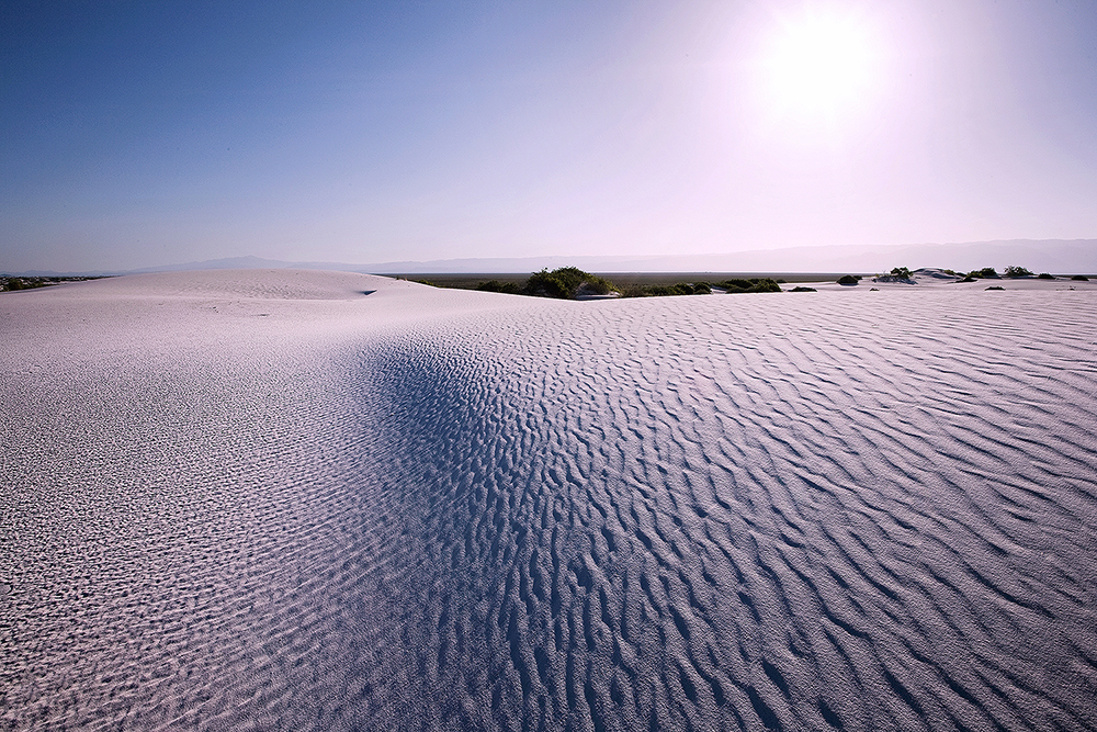 Morning at White Sands National Monument Fine art stock landscape photograph of the bright morning sun beating down on the beautiful gypsum sand dunes of White Sands National Monument, New Mexico.