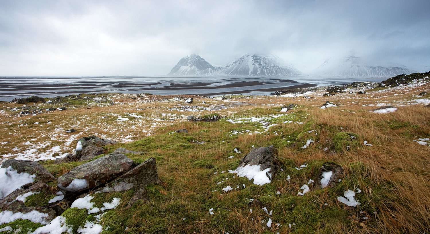 Fine art stock landscape photograph of the Stokksnes Peninsula in Iceland during a winter storm, as seen from the less-photographed side.