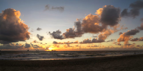 Fine art stock photograph of Las Olas Beach, in Fort Lauderdale, Florida, at dawn. The beautiful sunrise lights up the Atlantic Ocean gold and pink.