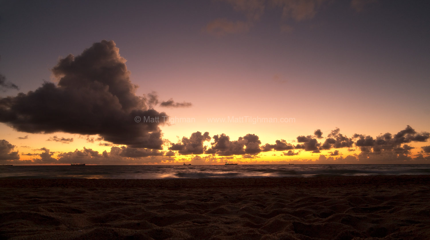 Fine art stock photograph of the South Florida coast, moments before sunrise. The tropical sky glows a deep gold, off the coast of Fort Lauderdale.