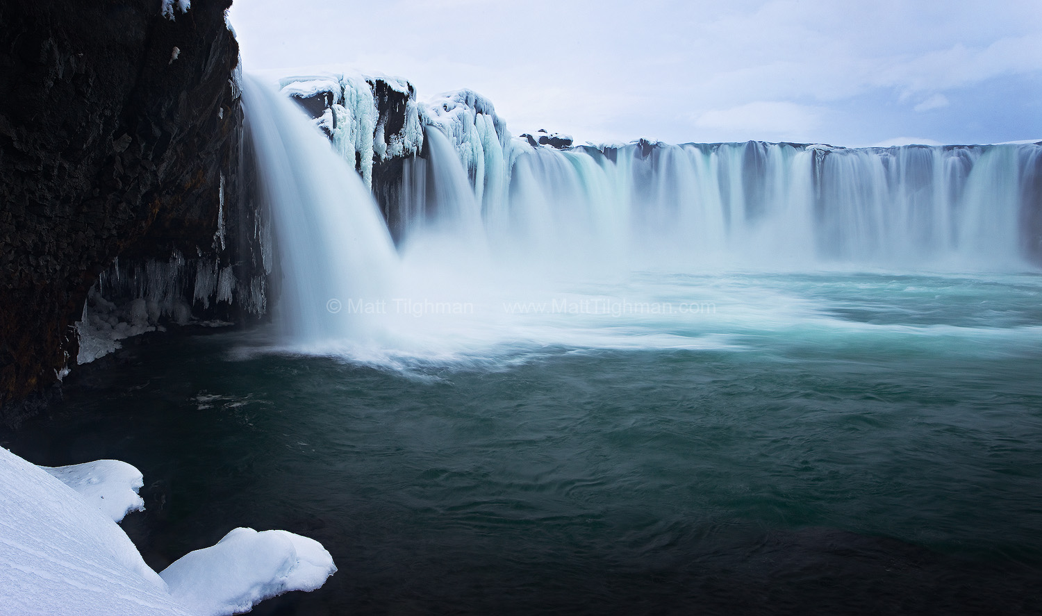 Peaceful Winter Scene at Godafoss, Iceland Fine art stock photograph of Godafoss, Iceland. Winter brings a beautiful fantasy-like landscape to this iconic waterfall. It also helps keep away the tourists.