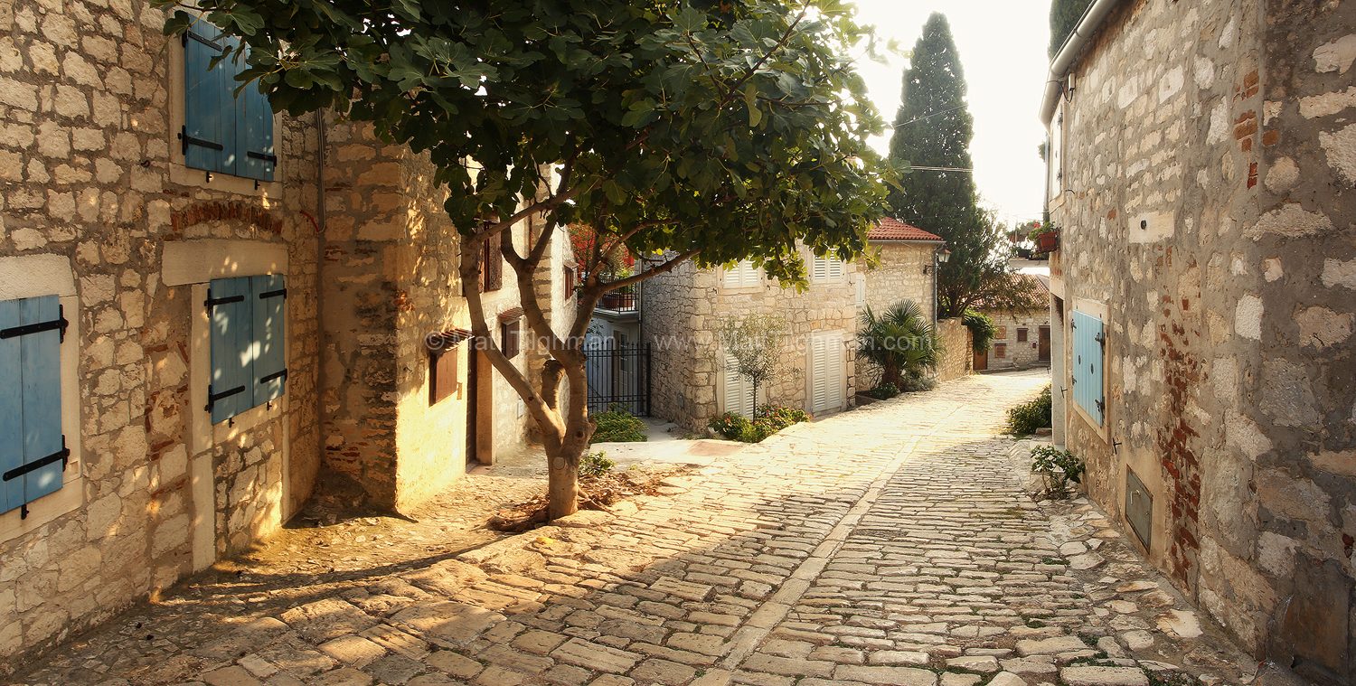 Fine art stock photograph of a peaceful alleyway in Rovinj, Croatia. The town of Rovinj is a romantic treasure along the coast of the Adriatic Sea.