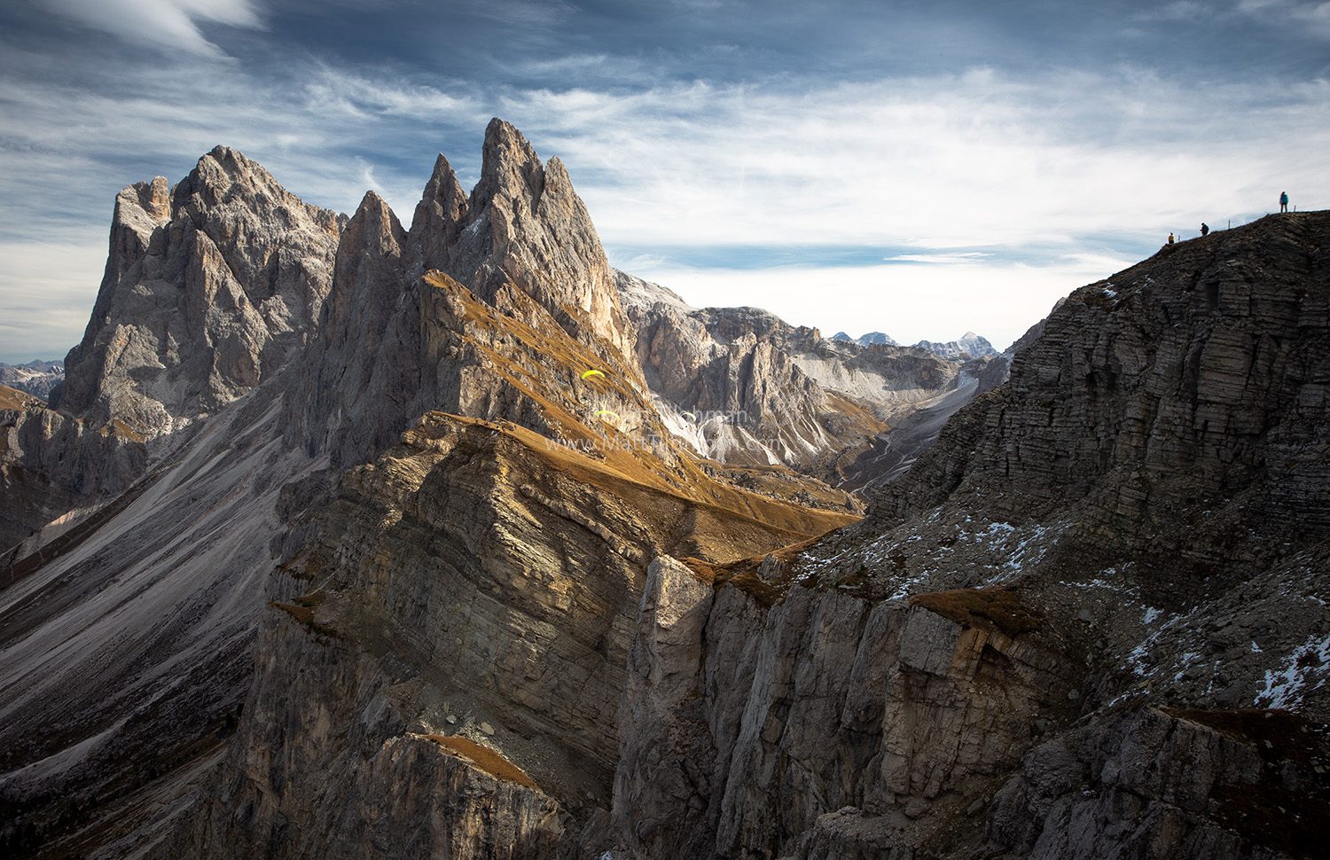 Fine art photograph of Seceda Mountain in the Italian Dolomites. Celebrating the end of tourist season, three locals take their paragliders to the sky.